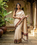 Kerala Saree with Blouse - Model wearing off-white cotton saree with gold and maroon border