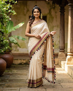 Kerala Saree with Blouse - Model wearing off-white cotton saree with gold and maroon border