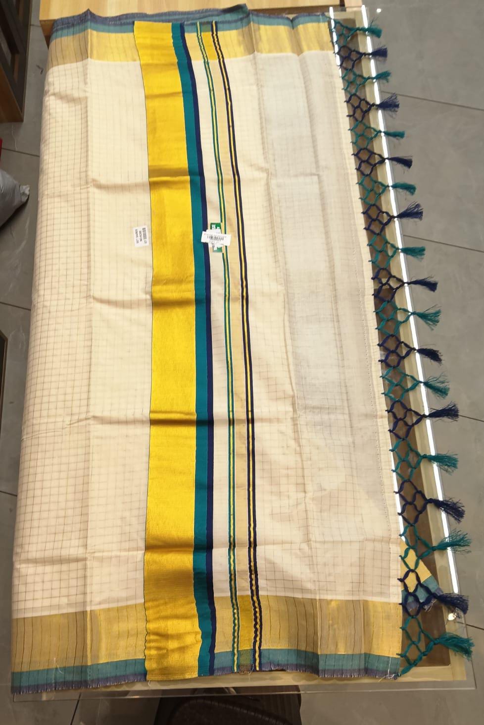 Kerala Set Saree - Flat lay showing gold, teal and navy border with tassel detail