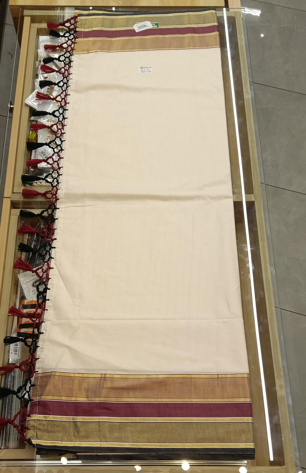 Kerala Saree with Blouse - Flat lay showing gold, maroon and black border with tassel detail