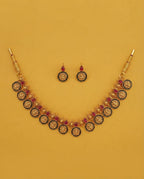 Temple coin necklace and earring set on yellow background
