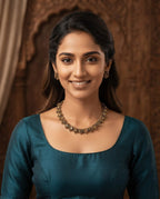 Floral antique necklace and earring set worn by model in teal kurta