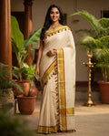 Kerala Kasavu Saree with colourful tassels - model wearing off-white cotton saree with gold and maroon border